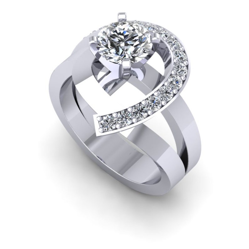 May include: A silver ring with a large round diamond in the center and smaller diamonds set in a curved band around the center stone.