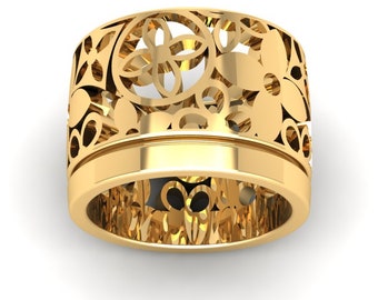 May include: A gold filigree ring with a floral design. The ring is wide and has a delicate, intricate pattern.