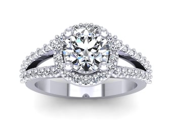 May include: A silver engagement ring with a large round center diamond surrounded by a halo of smaller diamonds. The band is split and features two rows of smaller diamonds.