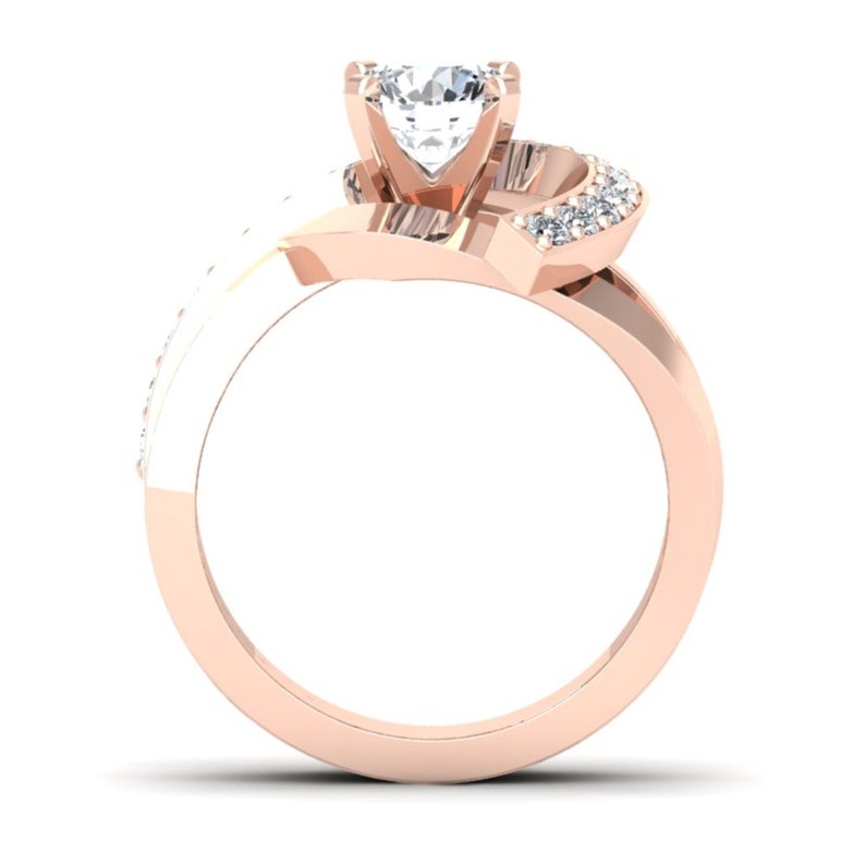 May include: A rose gold engagement ring with a large, clear center stone and smaller diamonds set in the band. The band is twisted and features a unique design.