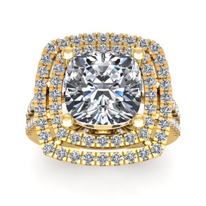 May include: A gold ring featuring a large, square-shaped diamond set within a double halo of smaller diamonds.