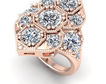 May include: A rose gold ring with a cluster of round diamonds set in a geometric design. The ring has a delicate, vintage-inspired look.