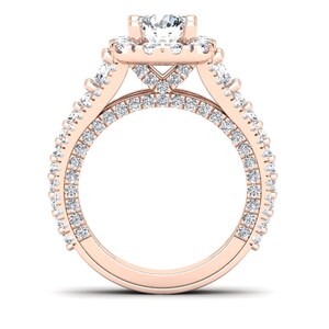 May include: A rose gold engagement ring with a large center diamond surrounded by a halo of smaller diamonds. The band is also set with smaller diamonds.