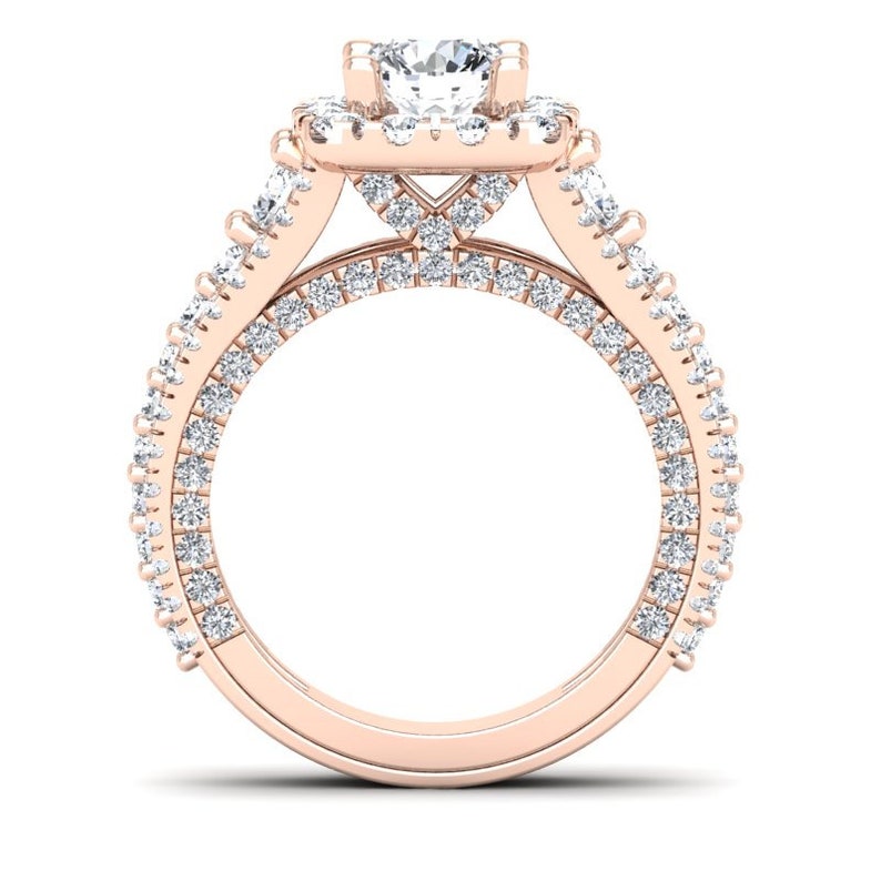 May include: A rose gold engagement ring with a large center diamond surrounded by a halo of smaller diamonds. The band is also set with smaller diamonds.