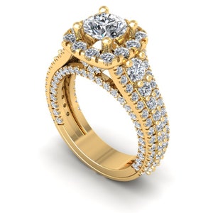 May include: A gold engagement ring with a large, round center diamond surrounded by smaller diamonds. The band is also set with diamonds.
