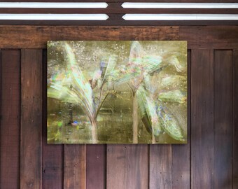 May include: Abstract art print featuring a blurred depiction of plants in shades of green, yellow, and blue. The artwork is mounted on a wooden wall with vertical planks. The painting has a textured, ethereal quality.
