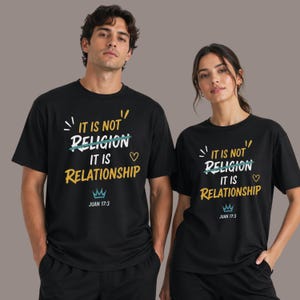 May include: Black t-shirts with the text "IT IS NOT RELIGION IT IS RELATIONSHIP" in white, yellow, and green. The shirts also feature a crown graphic and the text "JUAN 17:3". The shirts are worn by two people.