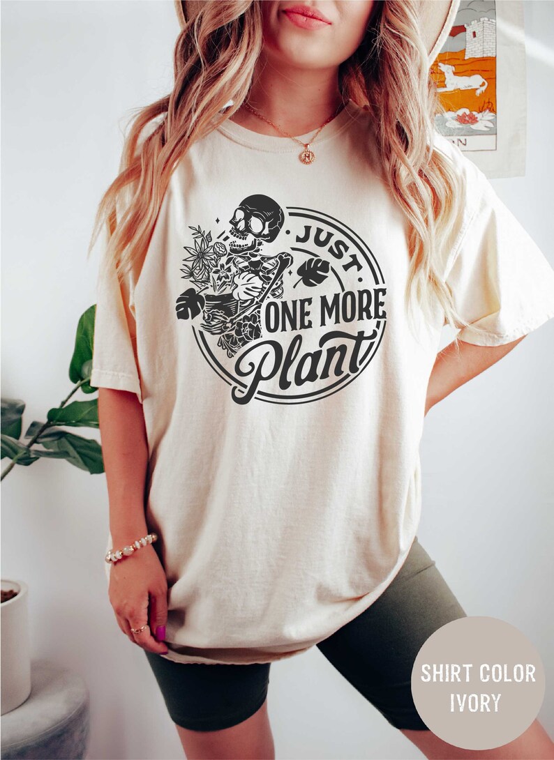 a woman wearing a t - shirt that says just one more planet