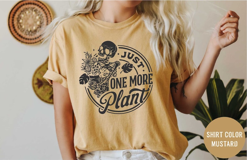 a woman wearing a t - shirt that says just one more plant