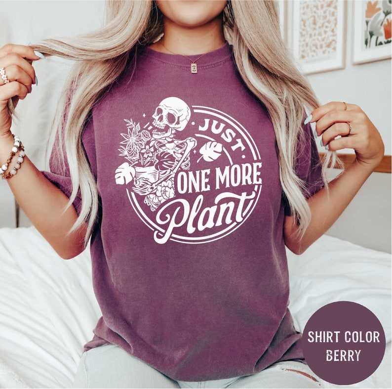a woman wearing a shirt that says just one more plant
