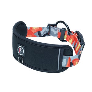 May include: A black and grey dog collar with a red, yellow and grey patterned strap. The collar has a black buckle and a silver D-ring. The collar has a black patch with a white letter "F" on it.