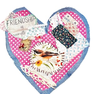 May include: A heart-shaped fabric collage with a denim border. The heart features pink polka dot fabric, patches of floral and patterned fabrics, and a central image of a bird. The text "FRIENDSHIP is everyth" is visible.