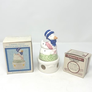 May include: A set of three ceramic mugs with a speckled, matte finish. Each mug is in a different colour: light blue, cream, and grey. The mugs have a simple, modern design and a comfortable handle. Ideal for coffee or tea.