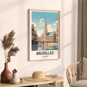 May include: A vintage-style travel poster featuring a colorful illustration of the Grand Place in Brussels, Belgium. The poster has a blue background with white clouds and the text "BRUXELLES BELGIQUE".