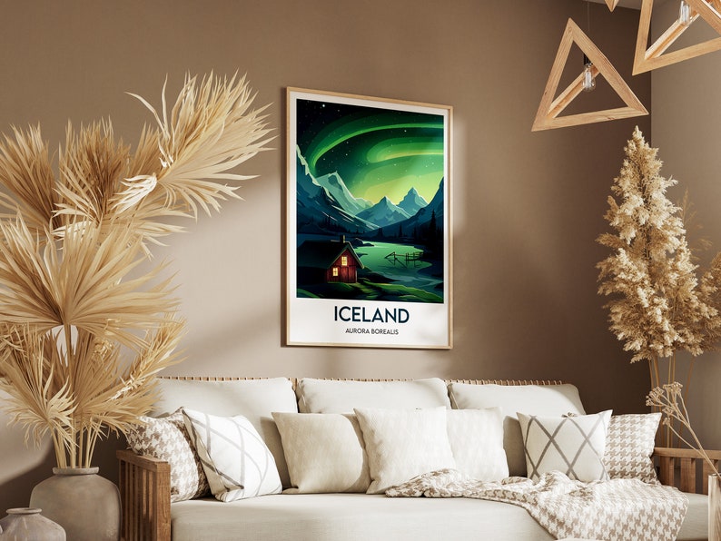 May include: A framed poster with a colorful illustration of a cabin in a mountain landscape with a lake and the aurora borealis in the sky. The poster has the text "Iceland" and "Aurora Borealis" printed on it.