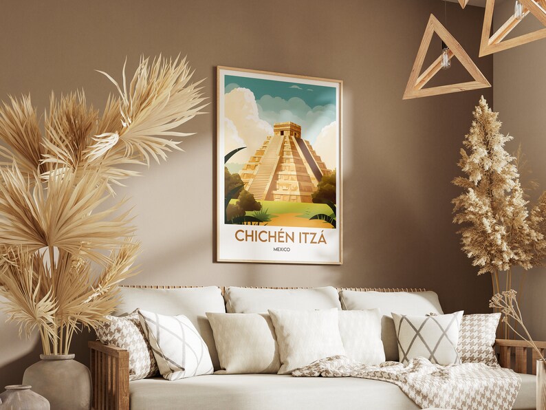 May include: A vintage-style poster with a colorful illustration of the Chichen Itza pyramid in Mexico. The poster has a brown frame and is hanging on a beige wall.
