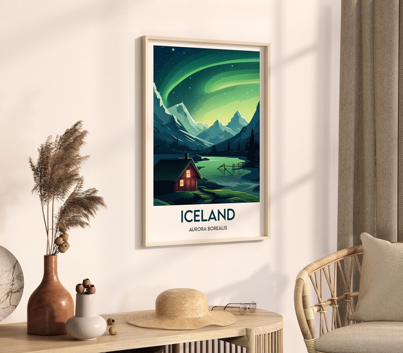 May include: A framed poster with a green and blue aurora borealis scene over a mountain range and a small red cabin. The poster has the text "Iceland, Aurora Borealis" at the bottom.