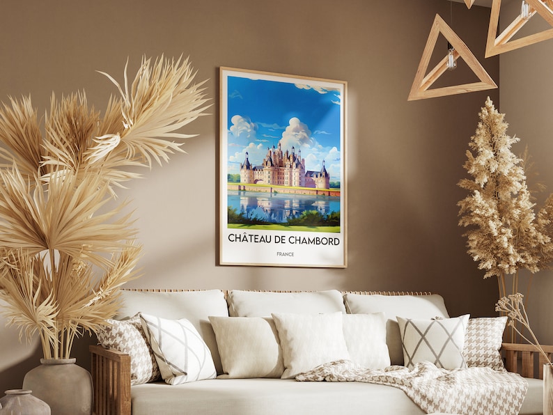 May include: A framed poster with a vintage travel illustration of Ch&acirc;teau de Chambord, a large French castle with a moat, surrounded by trees and a blue sky with white clouds. The text on the poster reads "Ch&acirc;teau de Chambord, France".