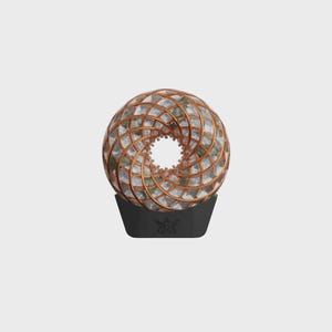 May include: A spherical, decorative object with a copper-colored, geometric lattice design. The interior is filled with a light-colored, textured material. It sits on a black, trapezoidal base with a stylized emblem.