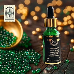 May include: A green glass bottle of Sacred Ritual Oils with a gold dropper, black label, and gold accents. The label reads "Caviar & 24K Gold Anti Aging, Plumping & UV Protect." The bottle is 1 oz. in size. Green beads and a gold bowl are in the background.