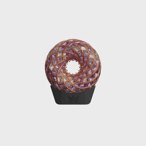 May include: A decorative sphere with a central hole, featuring a spiral design of purple and clear glass pieces, framed by copper-colored metal. The sphere sits on a black base with a decorative emblem.