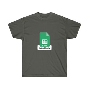 May include: A dark grey t-shirt featuring a green Google Sheets icon and the text "A Freak In the Sheets".