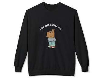 May include: A black long-sleeve sweatshirt featuring a cartoon character with a brown head and snout, wearing a grey sweater, light blue jeans, and red sneakers. Above the character, the text reads I AM JUST A CHILL GUY in white.