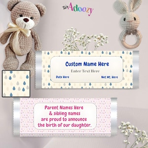 May include: Two personalized candy bar wrappers with text fields for custom names and dates. One wrapper has a cream background with blue and gray raindrop patterns. The other wrapper has a pink background and text announcing a daughter's birth.