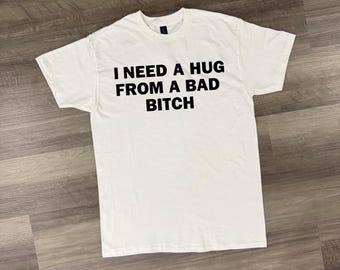 I Need a Hug From a Bad Bitch Shirt, Funny Viral Quote Tee, Trendy Streetwear Gift, TikTok Meme T-Shirt, Unisex Graphic Tee