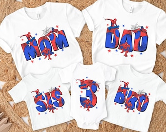 May include: Set of five white t-shirts with a Spiderman theme. The shirts feature the words "Mom", "Dad", "Sis", "Bro", and the number "3" with Spiderman characters on each. The shirts are perfect for a family matching outfit.