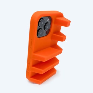 May include: Orange phone case with a textured, raised design. The case has a cutout for the camera lens and a raised lip around the screen.