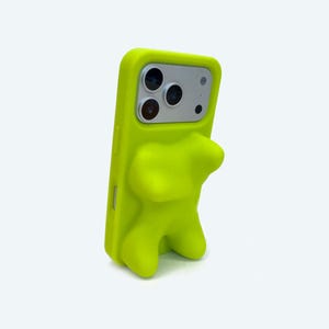 May include: A neon green phone case with a bear-shaped design. The case has a smooth texture and wraps around the phone, with cutouts for the camera and buttons. The phone case is designed to protect the phone.