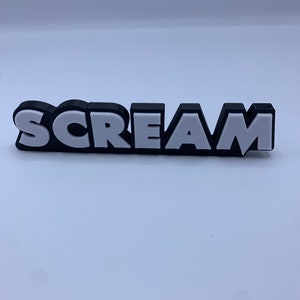 Könnte beinhalten: Das Wort "SCREAM" in 3D in Schwarz und Weiß mit einer fetten, cartoonartigen Schrift.