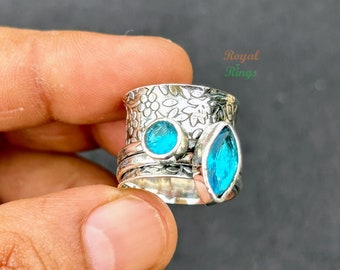 Blautopas Spinner Ring - Gelassene Schönheit und ruhige Bewegung