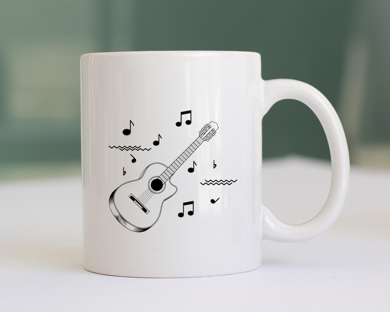 May include: White ceramic mug with a black and white illustration of an acoustic guitar and musical notes.