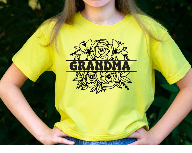 May include: A yellow t-shirt with a black floral design and the word "GRANDMA" in a retro font.