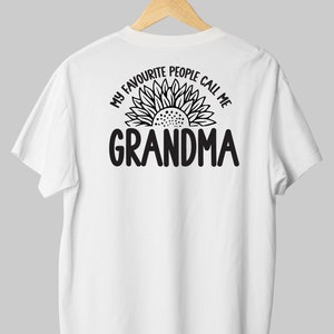 May include: White t-shirt with a black sunflower graphic and the text "My favorite people call me Grandma".