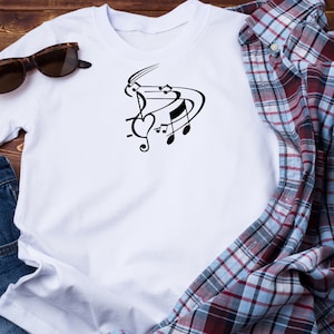 May include: White t-shirt with a black graphic of musical notes and a heart.