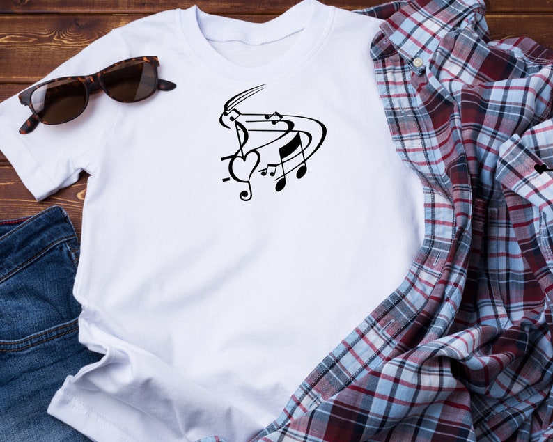 May include: White t-shirt with a black graphic of musical notes and a heart.