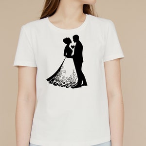 May include: White t-shirt with a black silhouette of a bride and groom embracing.