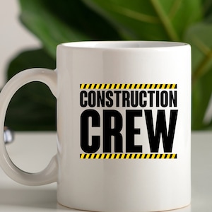 May include: White ceramic mug with a black and yellow graphic that says "Construction Crew".