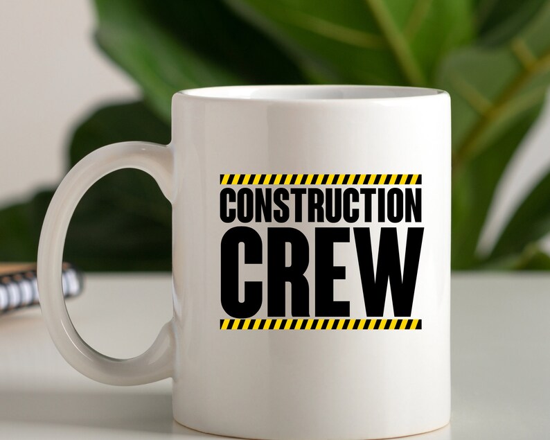 May include: White ceramic mug with a black and yellow graphic that says "Construction Crew".