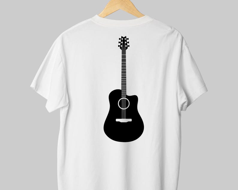 May include: White t-shirt with a black acoustic guitar graphic on the back. The guitar illustration features a detailed neck, sound hole, and body shape. The shirt is hanging on a wooden hanger.