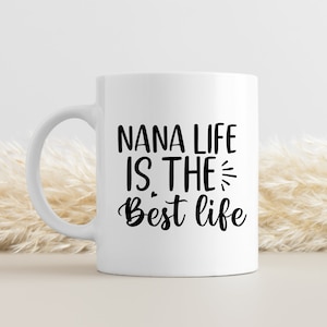 May include: White ceramic coffee mug with black text that reads "Nana life is the best life".