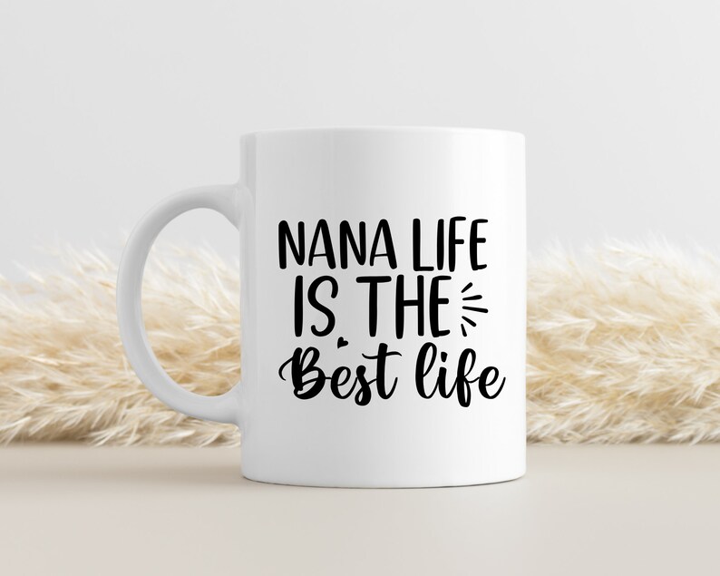 May include: White ceramic coffee mug with black text that reads "Nana life is the best life".
