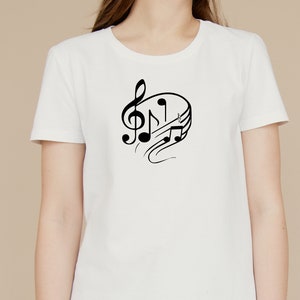 May include: White t-shirt with a black musical note design. The design features a treble clef and musical notes.
