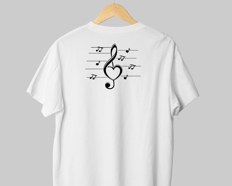May include: White t-shirt with a black treble clef design featuring a heart in the middle of the clef. The clef is on a staff with musical notes.