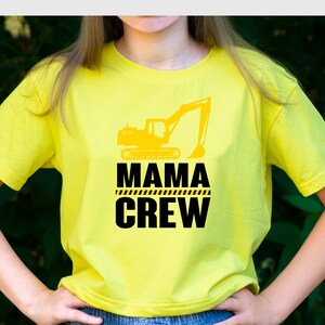May include: Yellow t-shirt with a black graphic of an excavator and the text "Mama Crew".