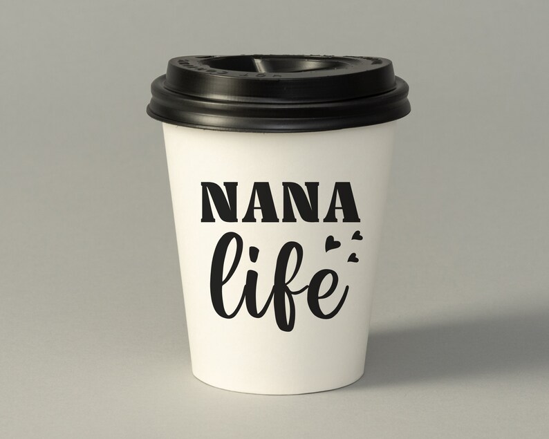 May include: White to-go coffee cup with a black lid. The cup has the text "NANA life" printed on it in black.