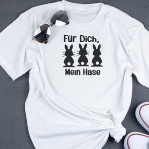 May include: White t-shirt with a black graphic of three bunnies and the text "F&uuml;r Dich, Mein Hase".